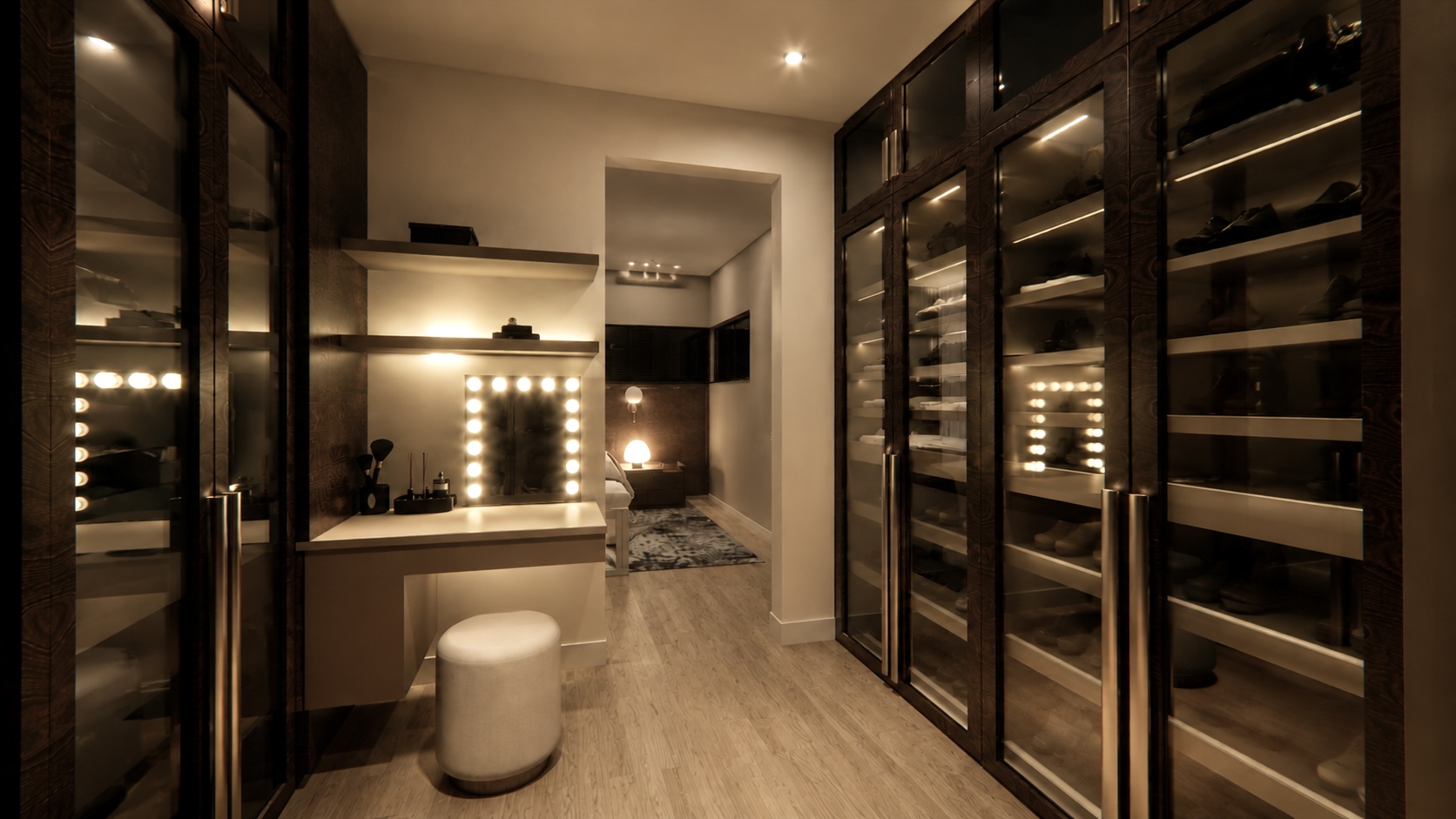 Walk-in closet with dark glass-front wardrobes and illuminated vanity