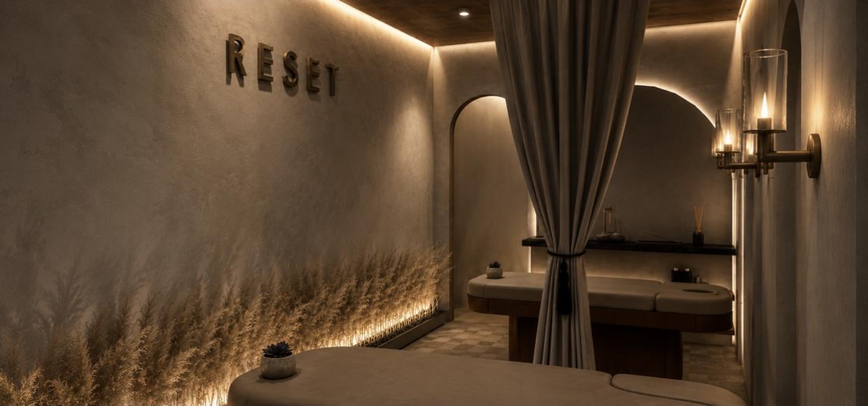 Sage & Serenity Spa — RESET treatment room with drapery, sconces and pampas planter