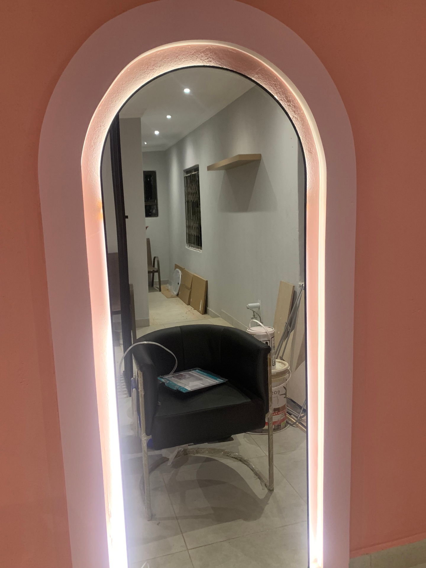 Hair Vine backlit arched mirror in coral alcove