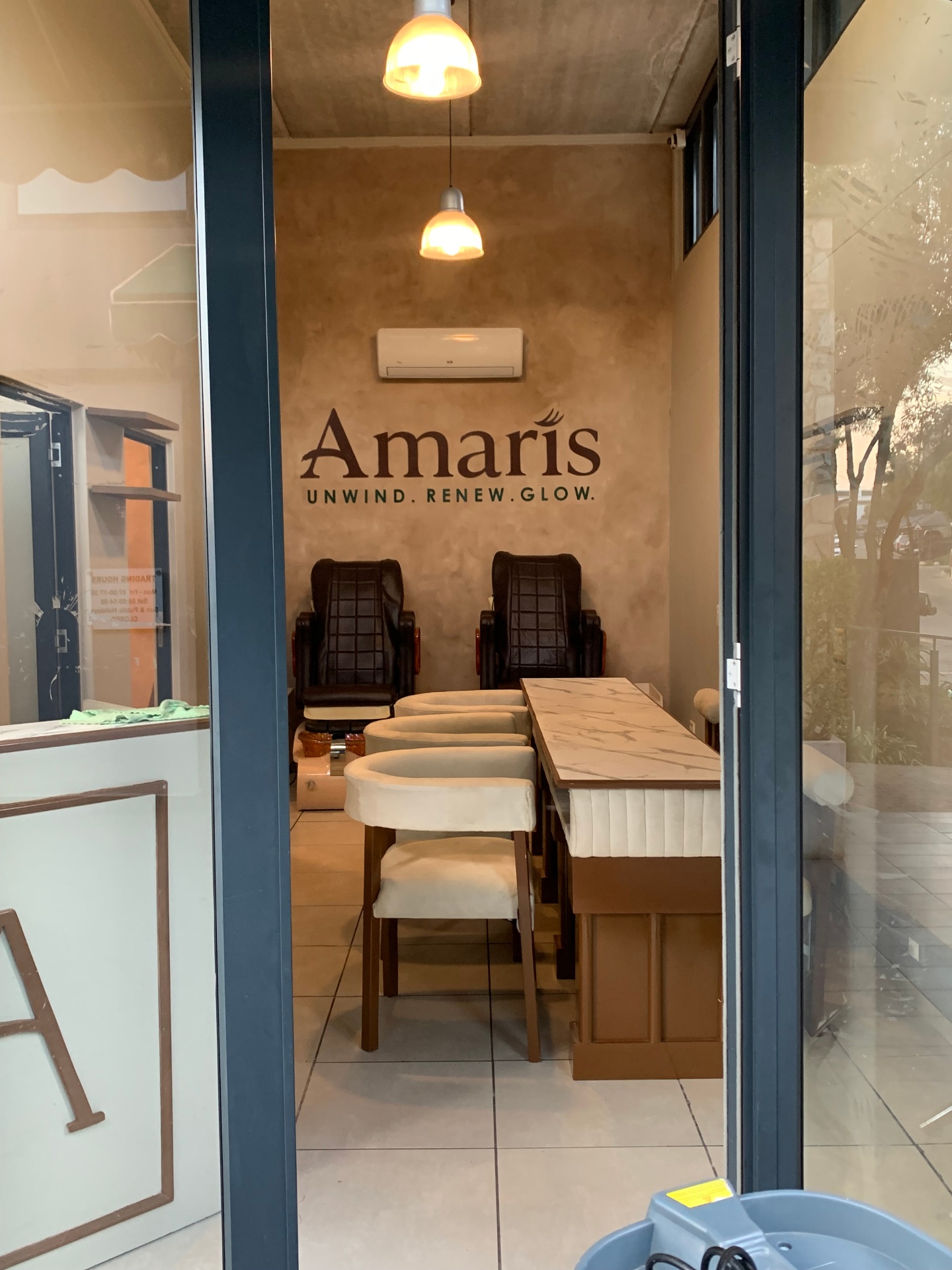 Amaris Spa manicure bar with pedicure chairs and branded feature wall