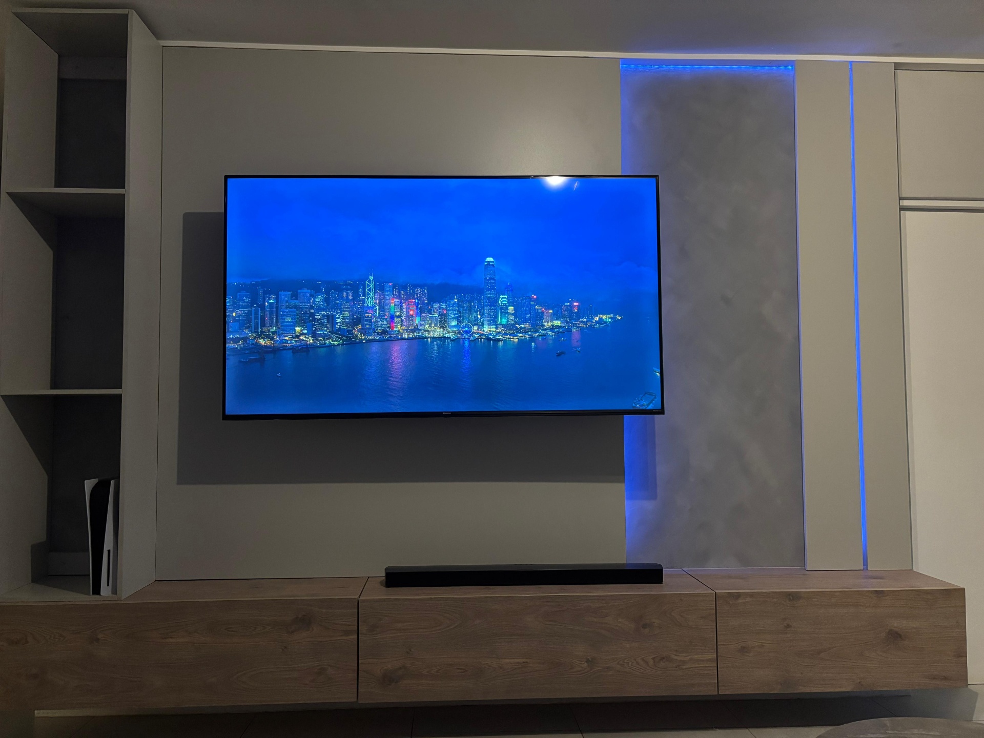 Media wall at night with blue LED accent and polished plaster panel