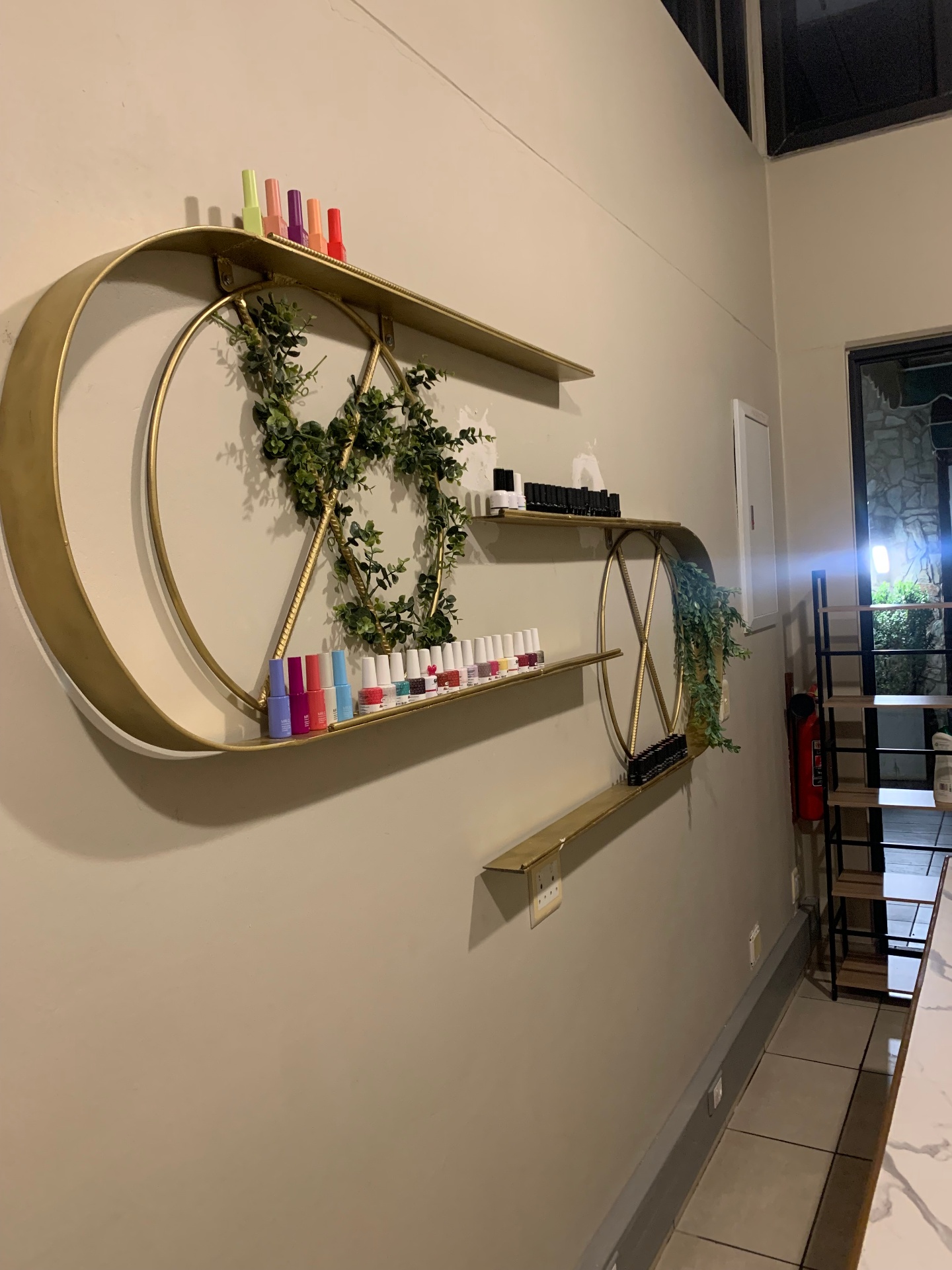 Amaris Spa brass shelving display with nail polish range