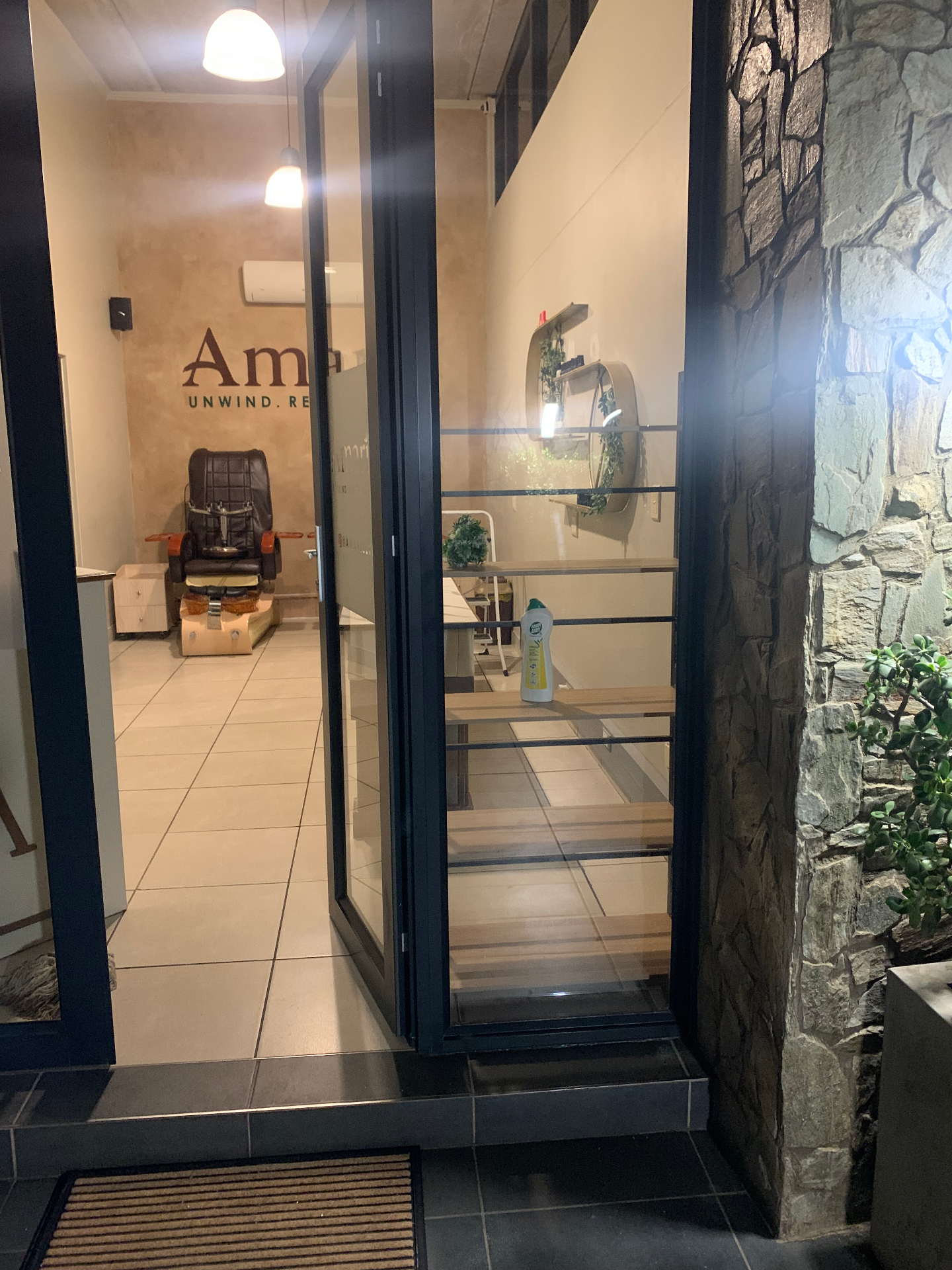 Amaris Spa entrance at night with pedicure chair and signage