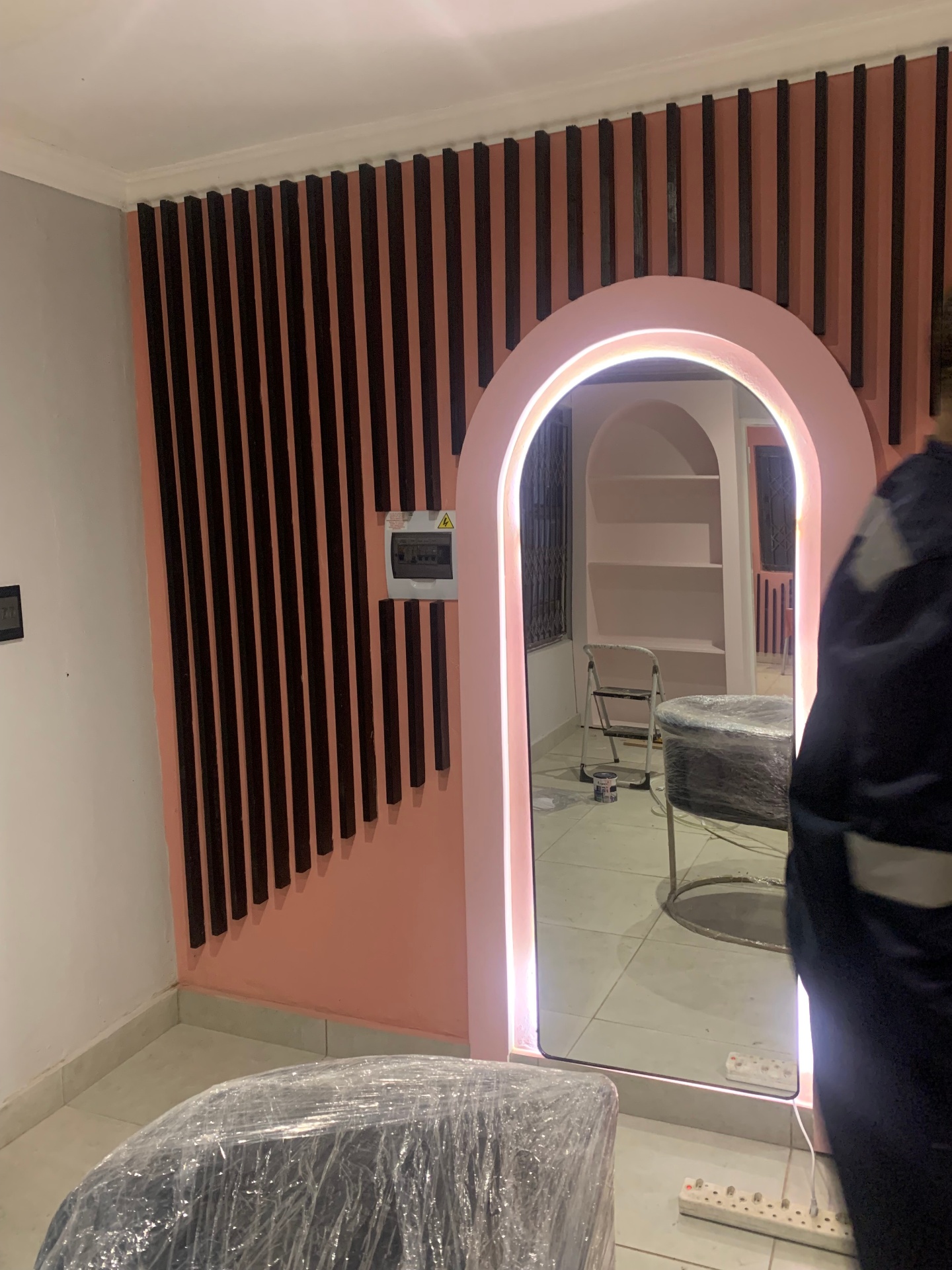 Hair Vine arched mirror against slatted black feature wall